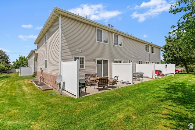 rear view of house featuring a patio, an outdoor living space, and brick siding