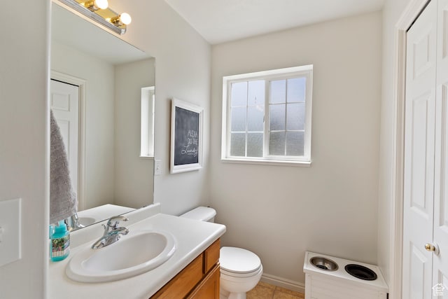 bathroom featuring toilet, vanity, and tile patterned floors