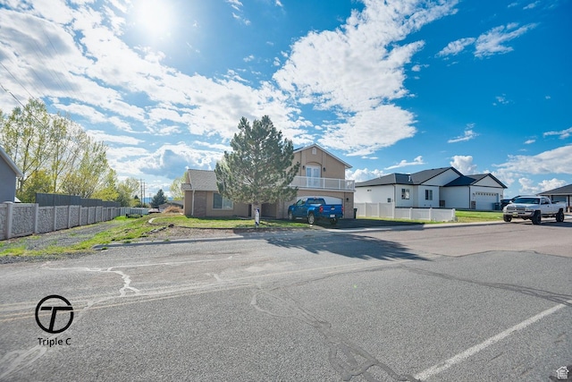 view of front of property featuring fence and a residential view