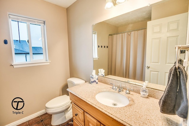 bathroom featuring baseboards, vanity, tile patterned floors, toilet, and curtained shower
