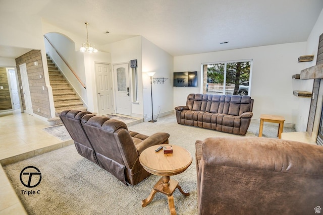 carpeted living room with stairs, a fireplace, baseboards, and a chandelier