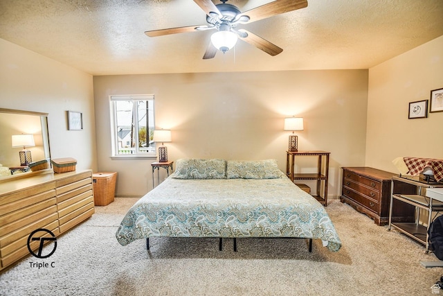 bedroom featuring carpet flooring, a textured ceiling, ceiling fan, and baseboards