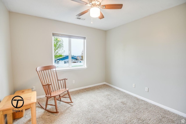 living area featuring ceiling fan, carpet, and baseboards