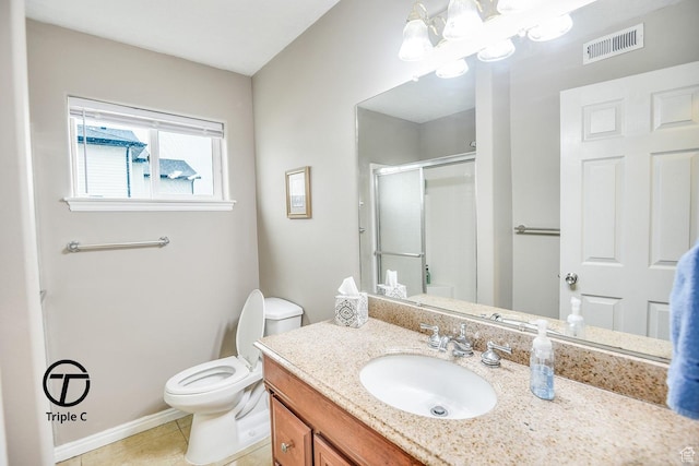 bathroom with a stall shower, toilet, vanity, a chandelier, and tile patterned flooring