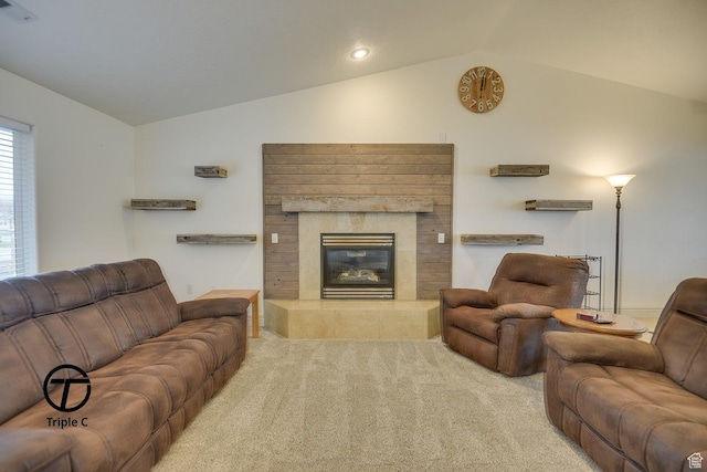 living area with vaulted ceiling, carpet, and a fireplace