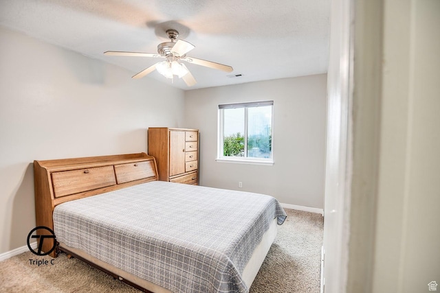 carpeted bedroom with baseboards and a ceiling fan