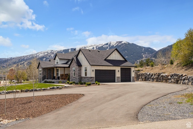 view of front of house featuring a mountain view, stone siding, a garage, and board and batten siding
