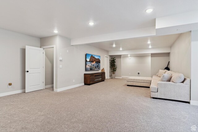 living area featuring recessed lighting, light carpet, and baseboards