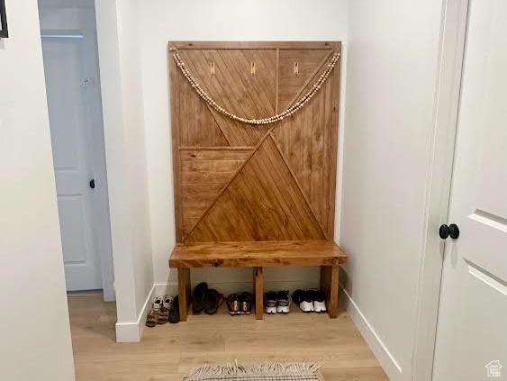 mudroom with baseboards and wood finished floors