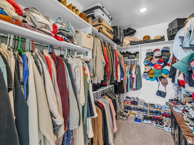 walk in closet with carpet floors