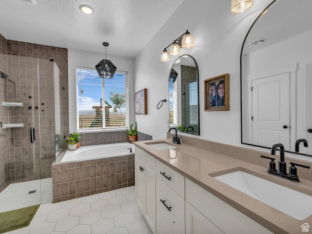 full bath with a stall shower, a garden tub, tile patterned floors, and double vanity