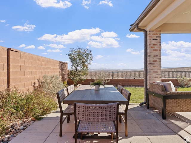 view of patio featuring a fenced backyard and outdoor dining area