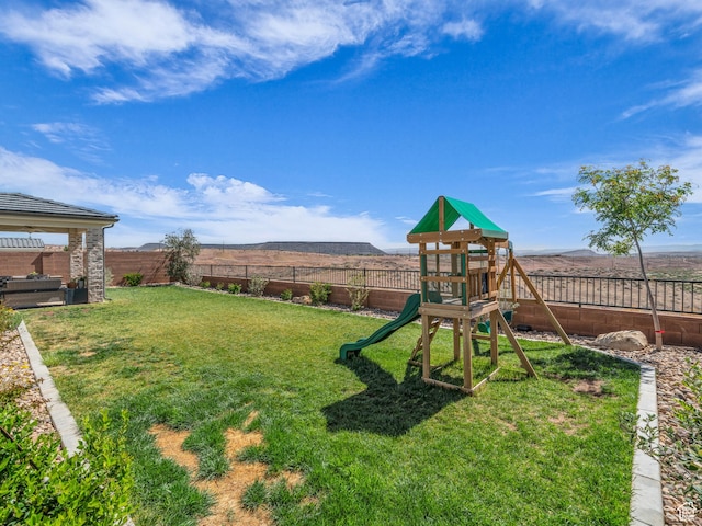 view of yard with a playground and a mountain view