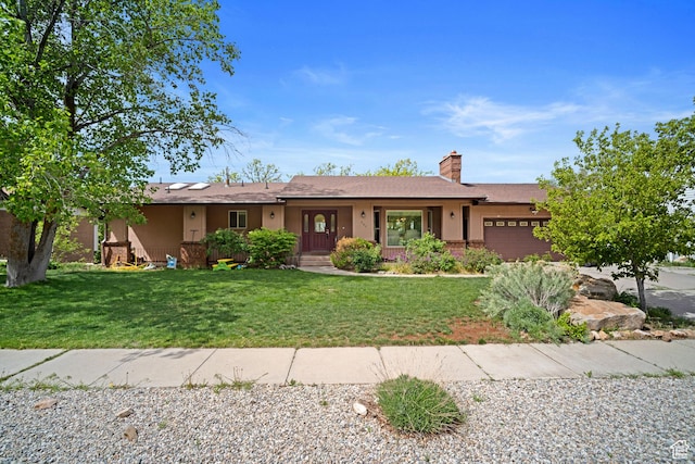 ranch-style house featuring a garage, a front yard, a chimney, and stucco siding
