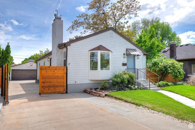 462 E 1700 S, Salt Lake City, UT 84115 - bungalow-style home featuring a chimney, an outbuilding, and a detached garage