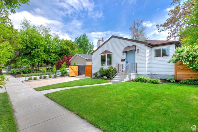 462 E 1700 S, Salt Lake City, UT 84115 - view of front of house with concrete driveway, a gate, and a chimney