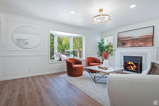 462 E 1700 S, Salt Lake City, UT 84115 - living area featuring wood finished floors, a chandelier, a tiled fireplace, baseboards, and recessed lighting