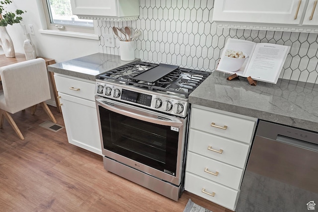 462 E 1700 S, Salt Lake City, UT 84115 - kitchen with stainless steel appliances, decorative backsplash, white cabinetry, and light wood-style flooring