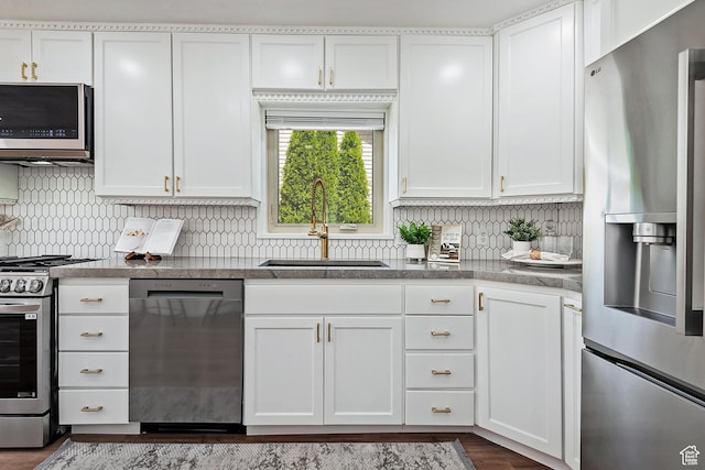 462 E 1700 S, Salt Lake City, UT 84115 - kitchen with appliances with stainless steel finishes, a sink, backsplash, and white cabinetry