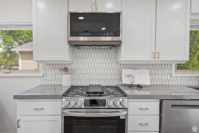 462 E 1700 S, Salt Lake City, UT 84115 - kitchen with appliances with stainless steel finishes, white cabinets, tasteful backsplash, and plenty of natural light