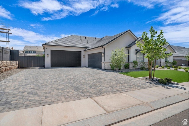 762 E Arina Way, Washington, UT 84780 - ranch-style house featuring an attached garage, decorative driveway, and stucco siding