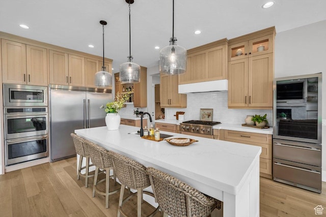 762 E Arina Way, Washington, UT 84780 - kitchen with built in appliances, under cabinet range hood, a sink, a breakfast bar, and recessed lighting