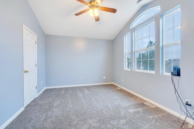 carpeted empty room featuring lofted ceiling, ceiling fan, and baseboards