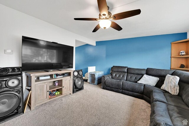 carpeted living area featuring ceiling fan