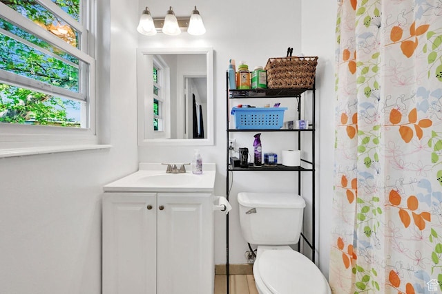 bathroom featuring vanity, toilet, and a shower with curtain