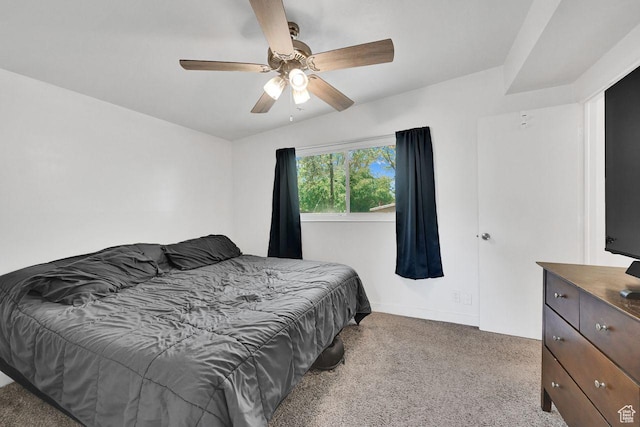 carpeted bedroom featuring baseboards and ceiling fan