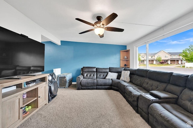 living room featuring ceiling fan and carpet