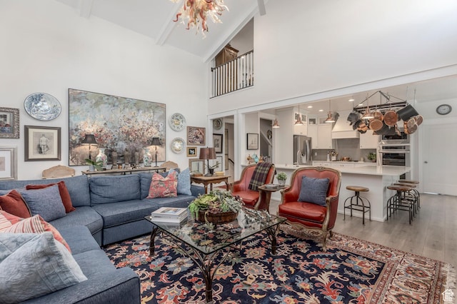 11243 S Prosperity Rd, South Jordan, UT 84009 - living area with light wood-type flooring, a high ceiling, and beamed ceiling