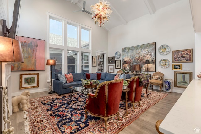 11243 S Prosperity Rd, South Jordan, UT 84009 - living area featuring high vaulted ceiling, beam ceiling, a ceiling fan, wood finished floors, and baseboards