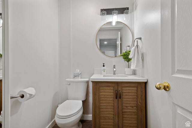 half bath featuring toilet and vanity