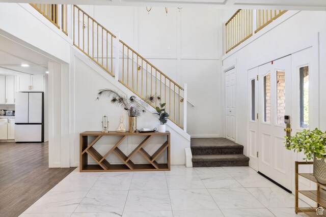 1890 W Rock Hollow Rd, Bluffdale, UT 84065 - entrance foyer with light marble finish flooring, stairway, and a high ceiling
