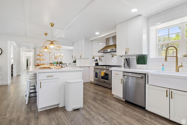 1890 W Rock Hollow Rd, Bluffdale, UT 84065 - kitchen with stainless steel appliances, wall chimney range hood, decorative backsplash, white cabinetry, and recessed lighting
