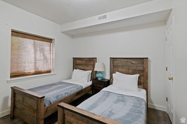 bedroom featuring wood finished floors and baseboards