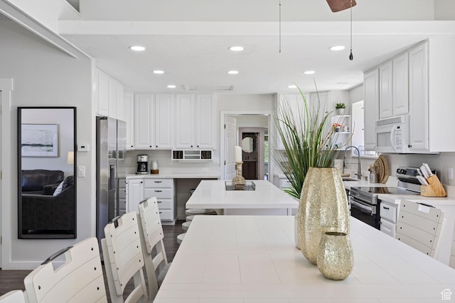 1890 W Rock Hollow Rd, Bluffdale, UT 84065 - kitchen featuring stainless steel appliances, recessed lighting, a sink, white cabinets, and light countertops