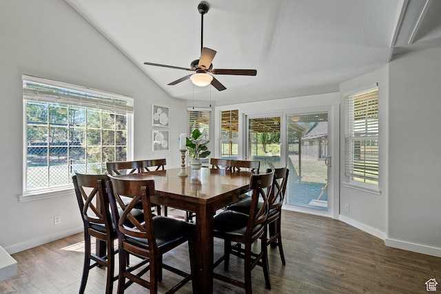 dining space with a ceiling fan, healthy amount of natural light, baseboards, wood finished floors, and lofted ceiling