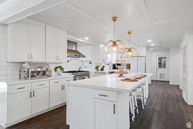 kitchen featuring wall chimney exhaust hood, decorative backsplash, white cabinets, recessed lighting, and light countertops