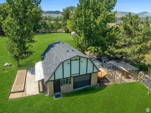 view of poultry coop with a mountain view and a lawn