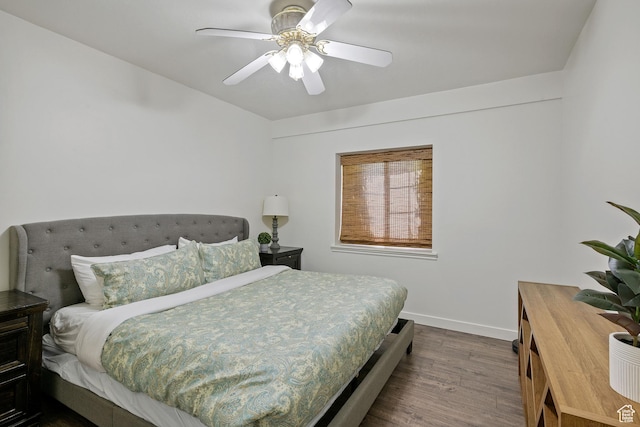 bedroom featuring dark wood-type flooring, baseboards, and ceiling fan