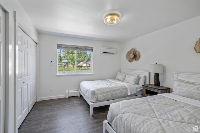 bedroom with a wall mounted AC, a baseboard heating unit, dark wood-type flooring, baseboards, and a closet