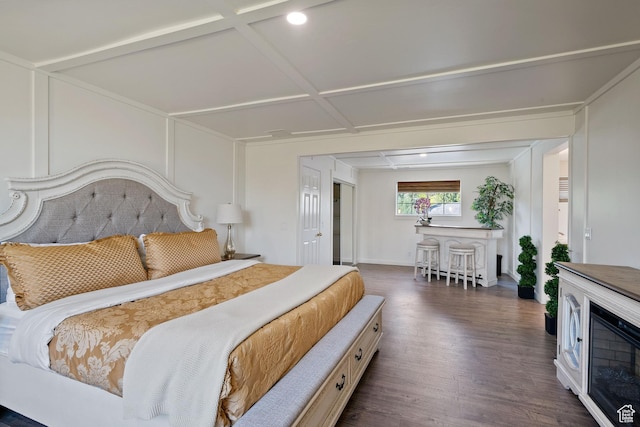 bedroom with dark wood-type flooring and baseboards