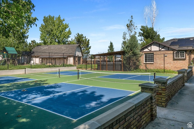 view of tennis court featuring fence and community basketball court