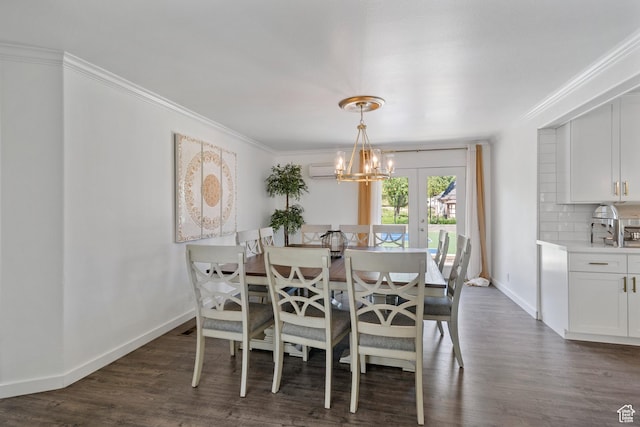 dining area featuring crown molding, dark wood-type flooring, baseboards, french doors, and a chandelier