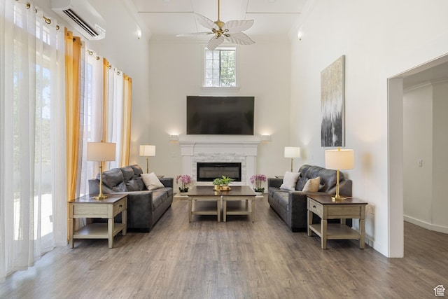 1890 W Rock Hollow Rd, Bluffdale, UT 84065 - living area with an AC wall unit, a high ceiling, crown molding, ceiling fan, and wood finished floors