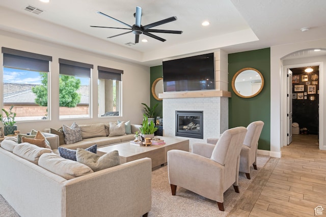 2883 S 3640 W, Hurricane, UT 84737 - living area featuring a ceiling fan, light wood-style floors, a raised ceiling, baseboards, and a fireplace