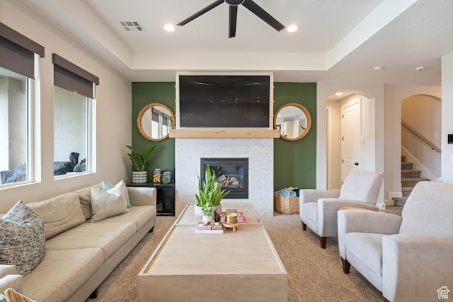 2883 S 3640 W, Hurricane, UT 84737 - carpeted living room featuring ceiling fan, arched walkways, a glass covered fireplace, stairs, and recessed lighting