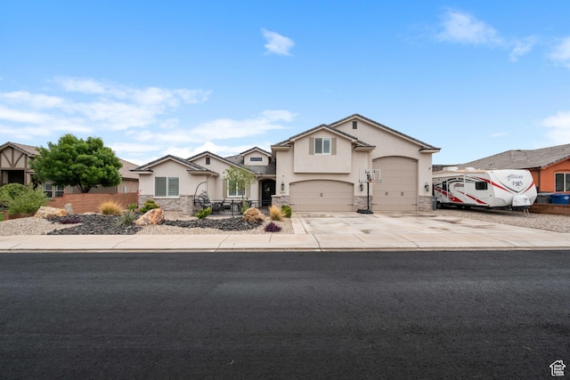 2883 S 3640 W, Hurricane, UT 84737 - traditional-style house with stucco siding, concrete driveway, fence, stone siding, and a garage